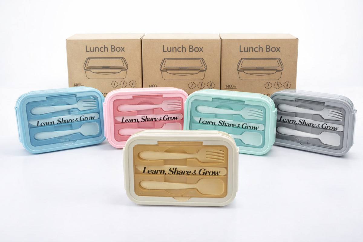 Bento lunch boxes with utensils, customised with the “Learn, Share & Grow” message.