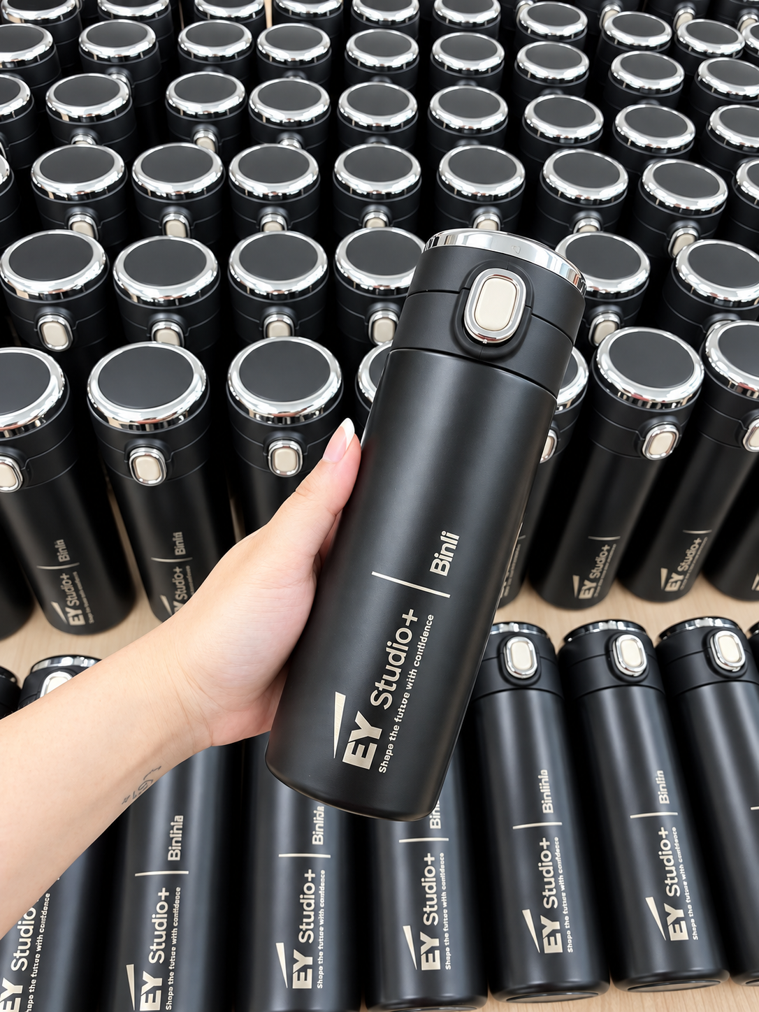 Black 400ml digital tumblers featuring EY Studio+ branding and laser-engraved individual names.