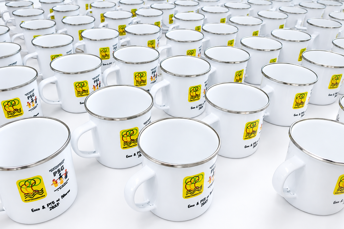 White enamel mugs featuring a customised Northbrooks Secondary School design