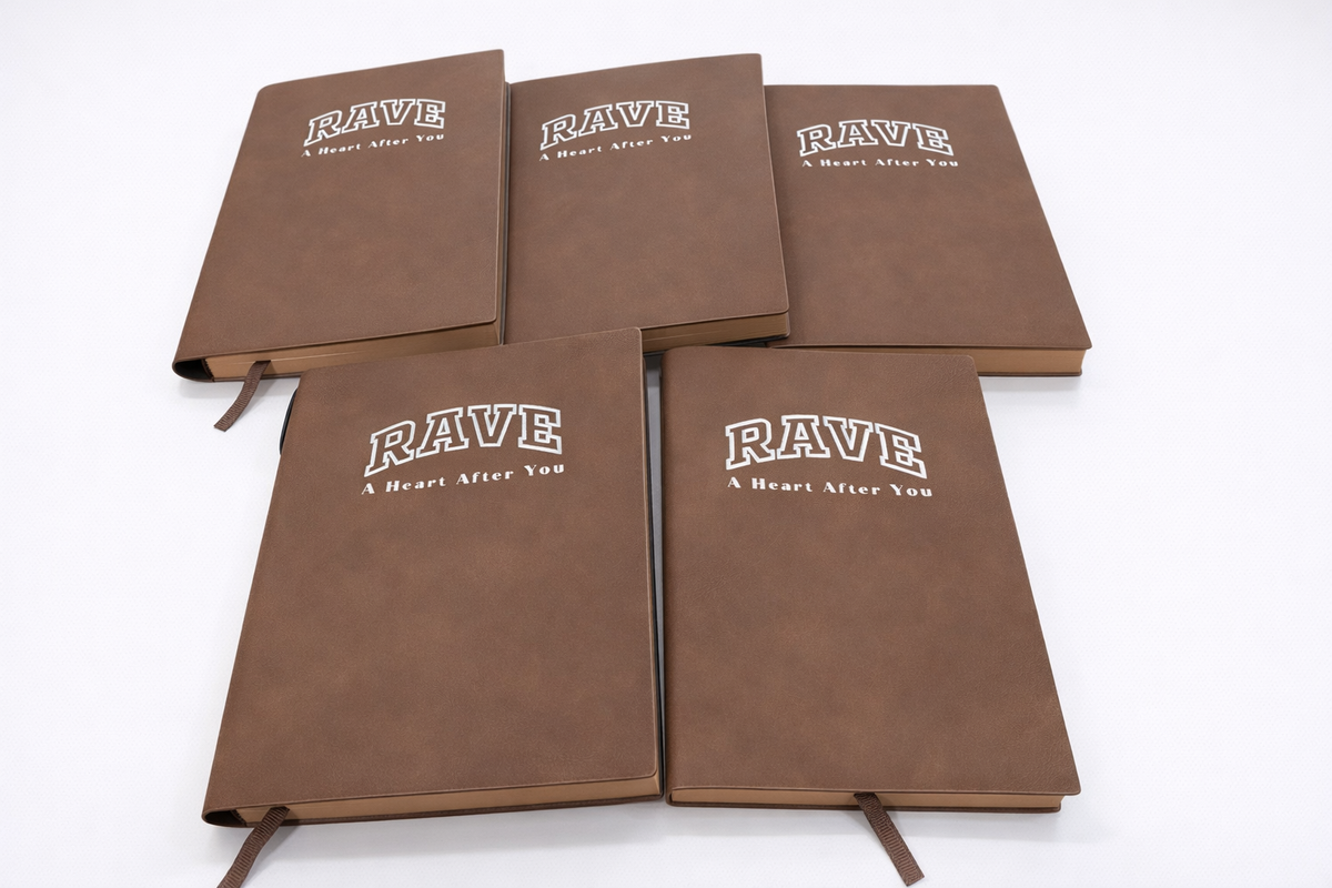 Brown soft cover PU leather soft notebooks customised with the RAVE logo on the covers.